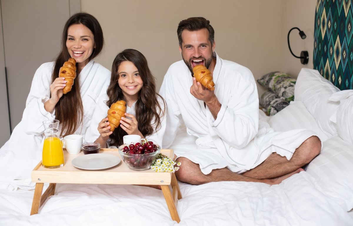 A family eating in a hotel room.