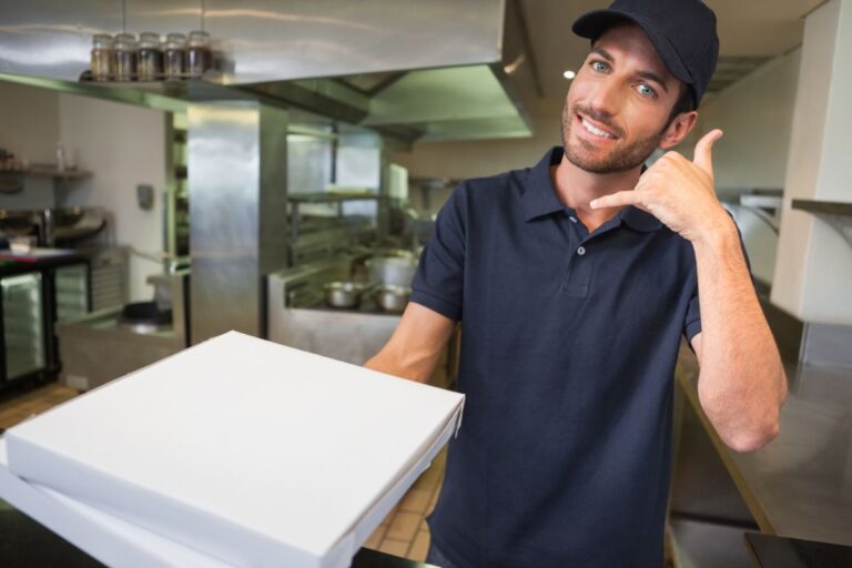 A delivery guy holding pizza.