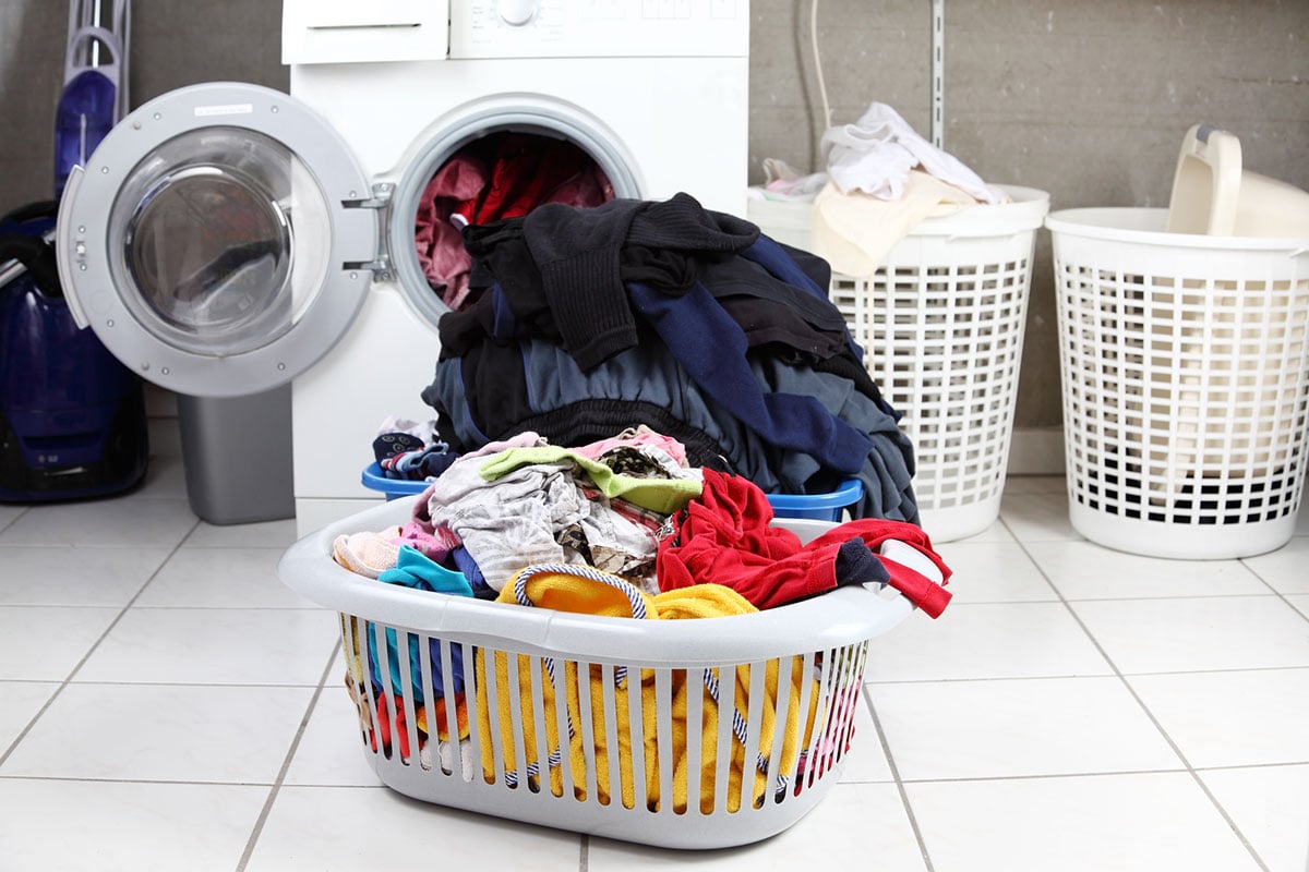 A dirty laundry and a washing machine.