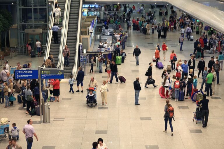 Airport lobby full of passengers.