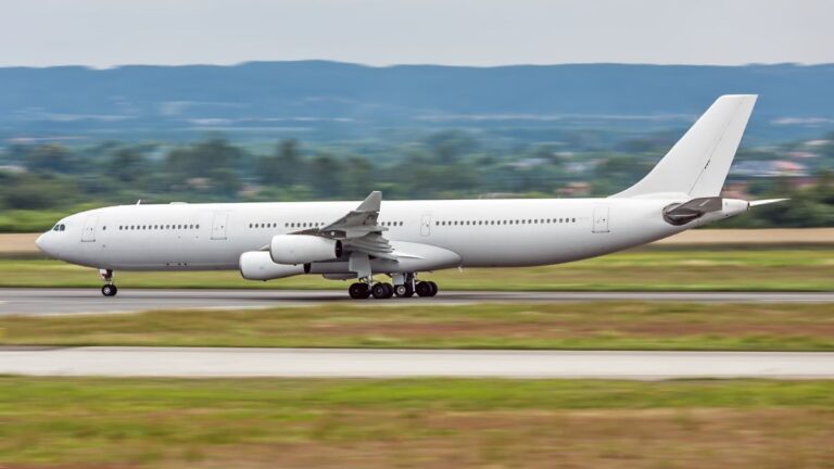 A four engine passenger jet, landing.