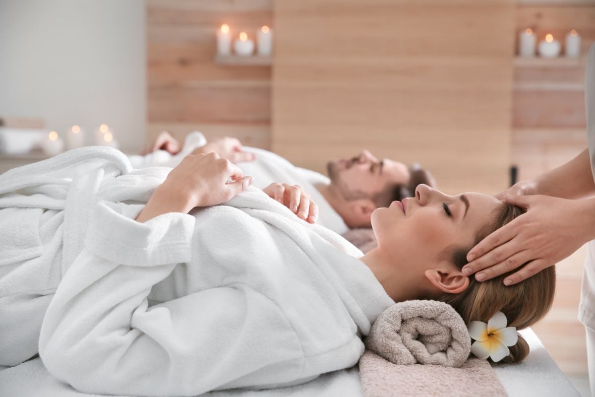 A couple enjoying a hand massage.