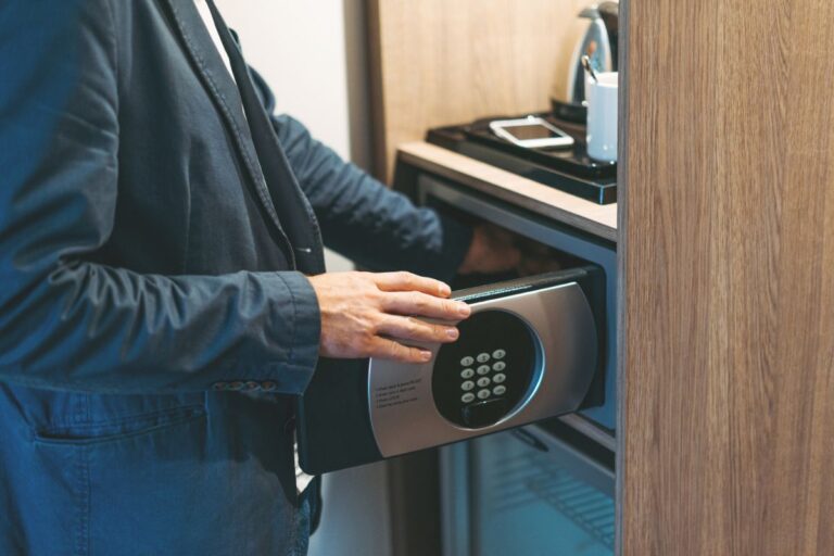 A person opening a safe on a hotel.