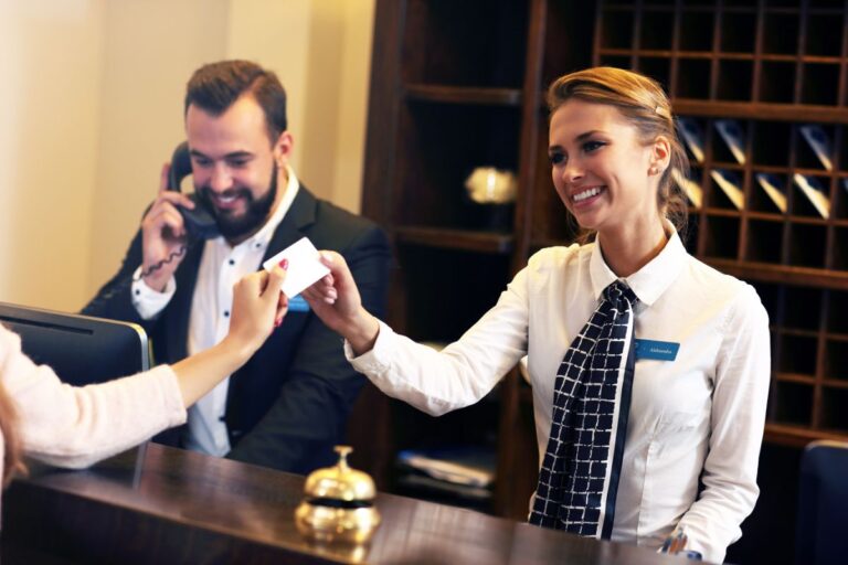 Guest handing a card as payment to the front desk.