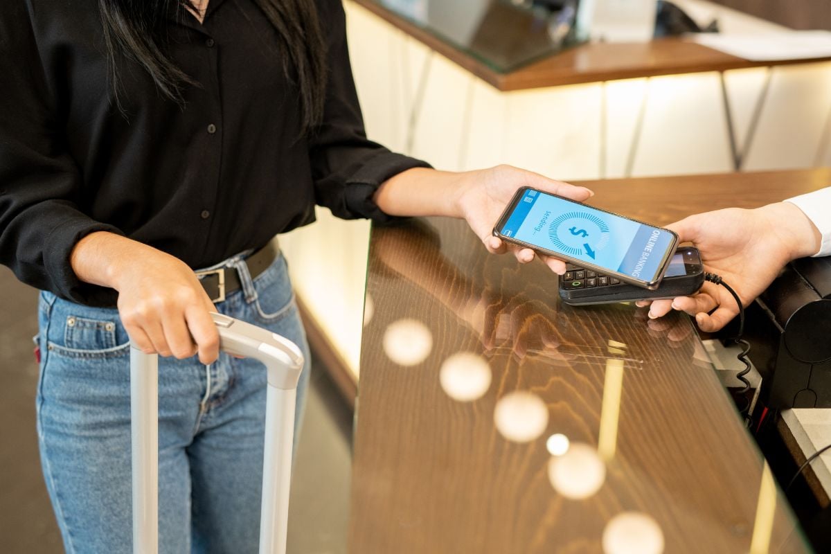 A woman paying using her phone through online banking.