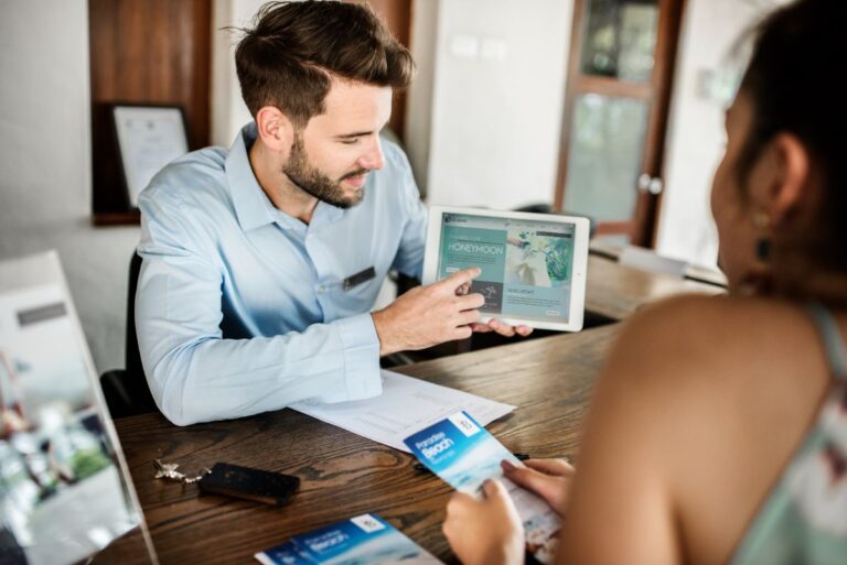 A concierge helping a guest for honeymoon plan.