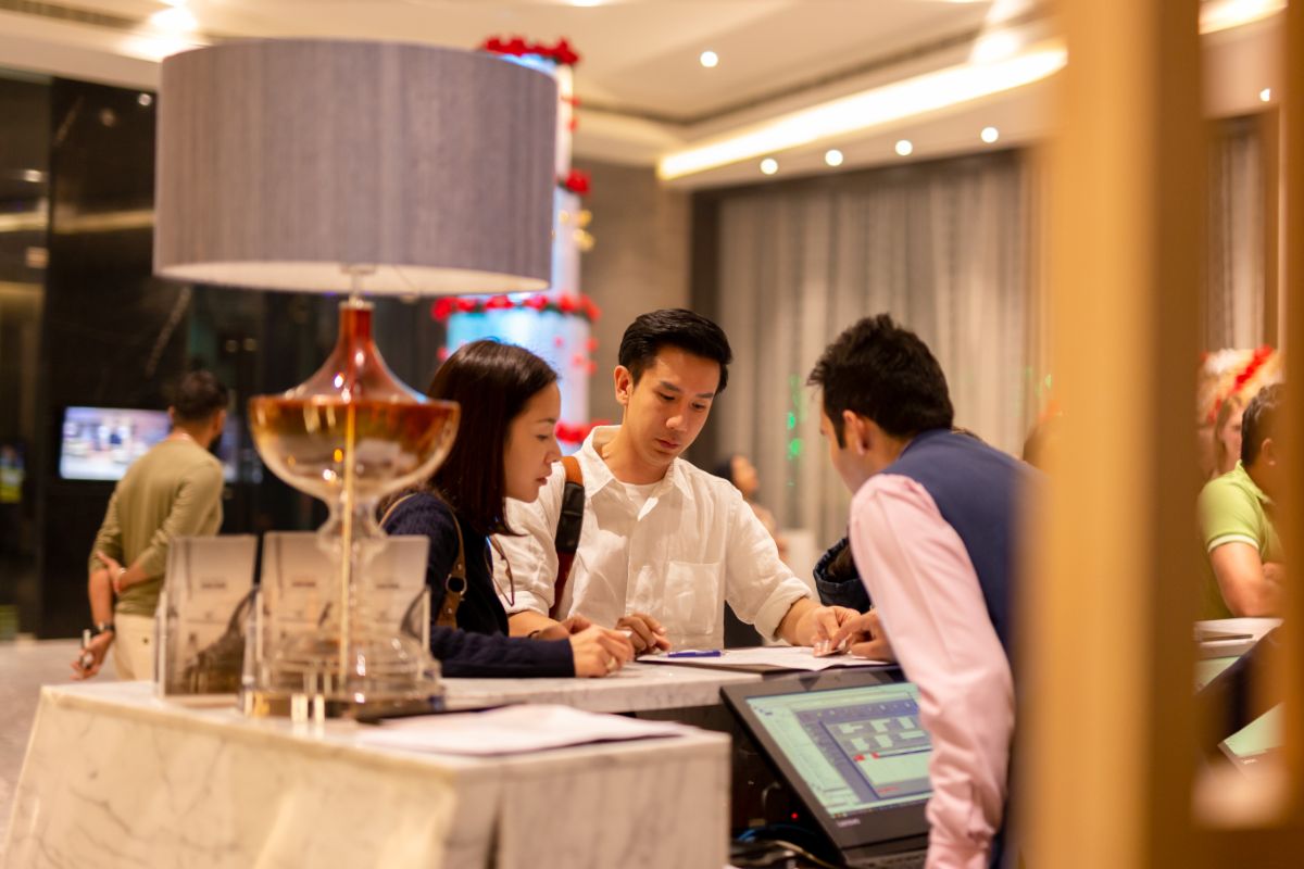 A couple on a hotel reception area.