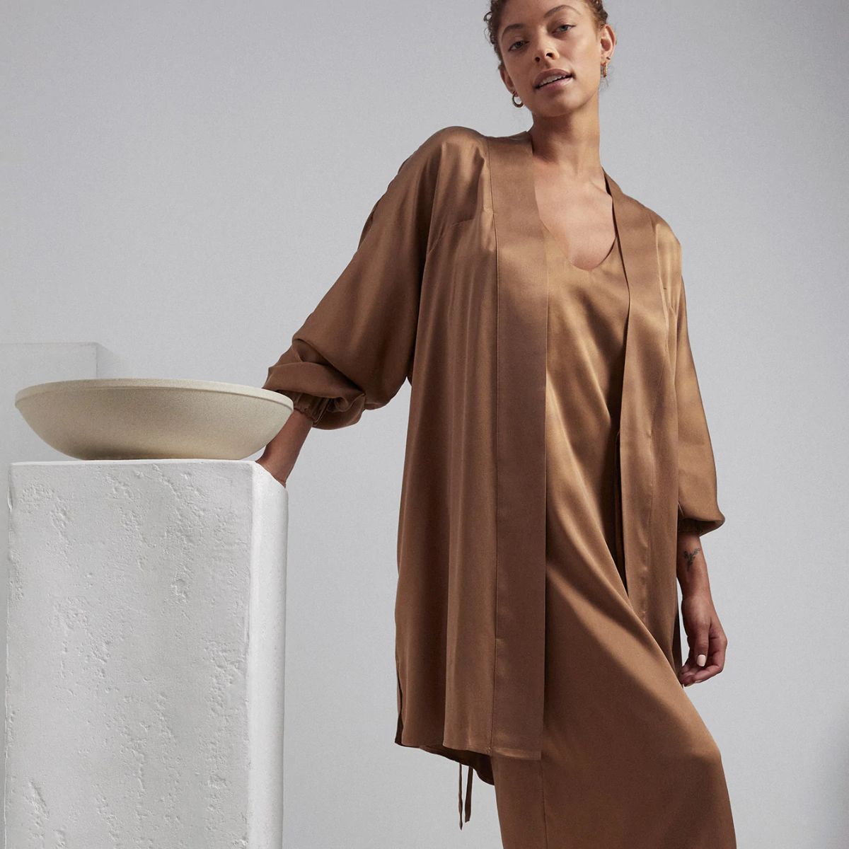 A woman wearing Lunya Washable Silk Robe.