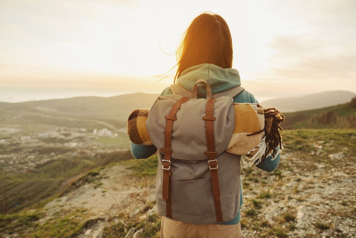 A woman carrying a frameless backpack.