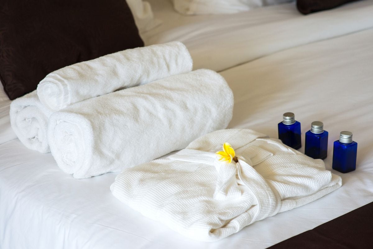 Different types of hotel amnesties on the bed.