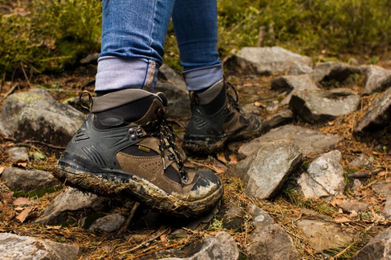 A person hiking with a muddy hiking boots.