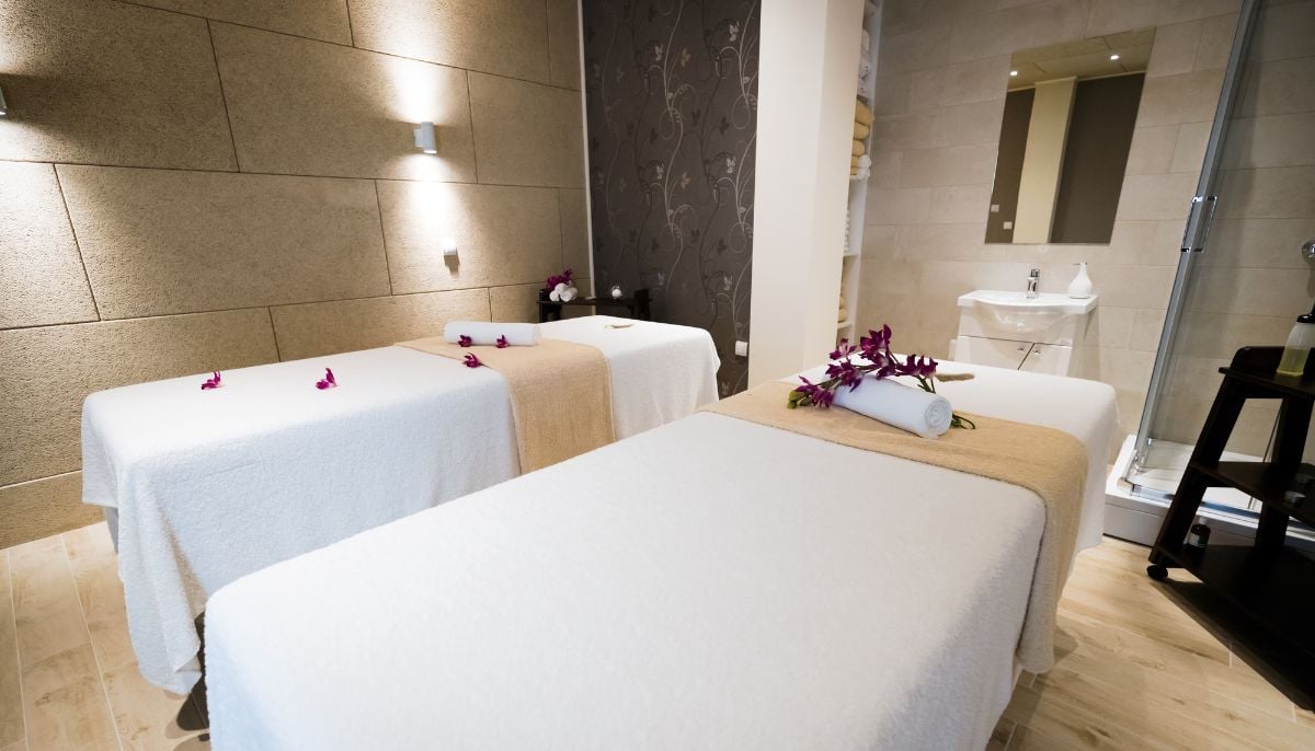 A spa on the hotel with towels and flowers.