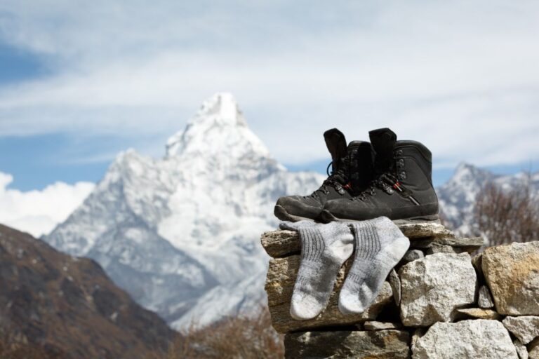 Hiking boots and socks on top of the mountain.