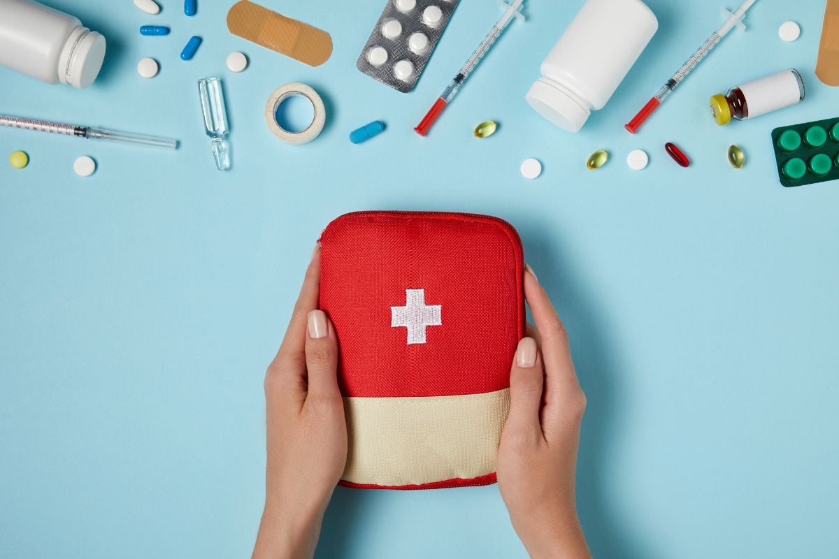 A first aid kit and different types of medicine.