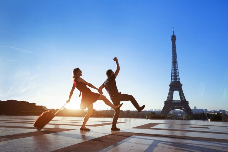 A couple enjoy dancing near the Eiffel Tower.