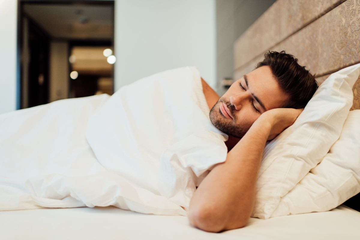 A man sleeping soundly on a hotel.