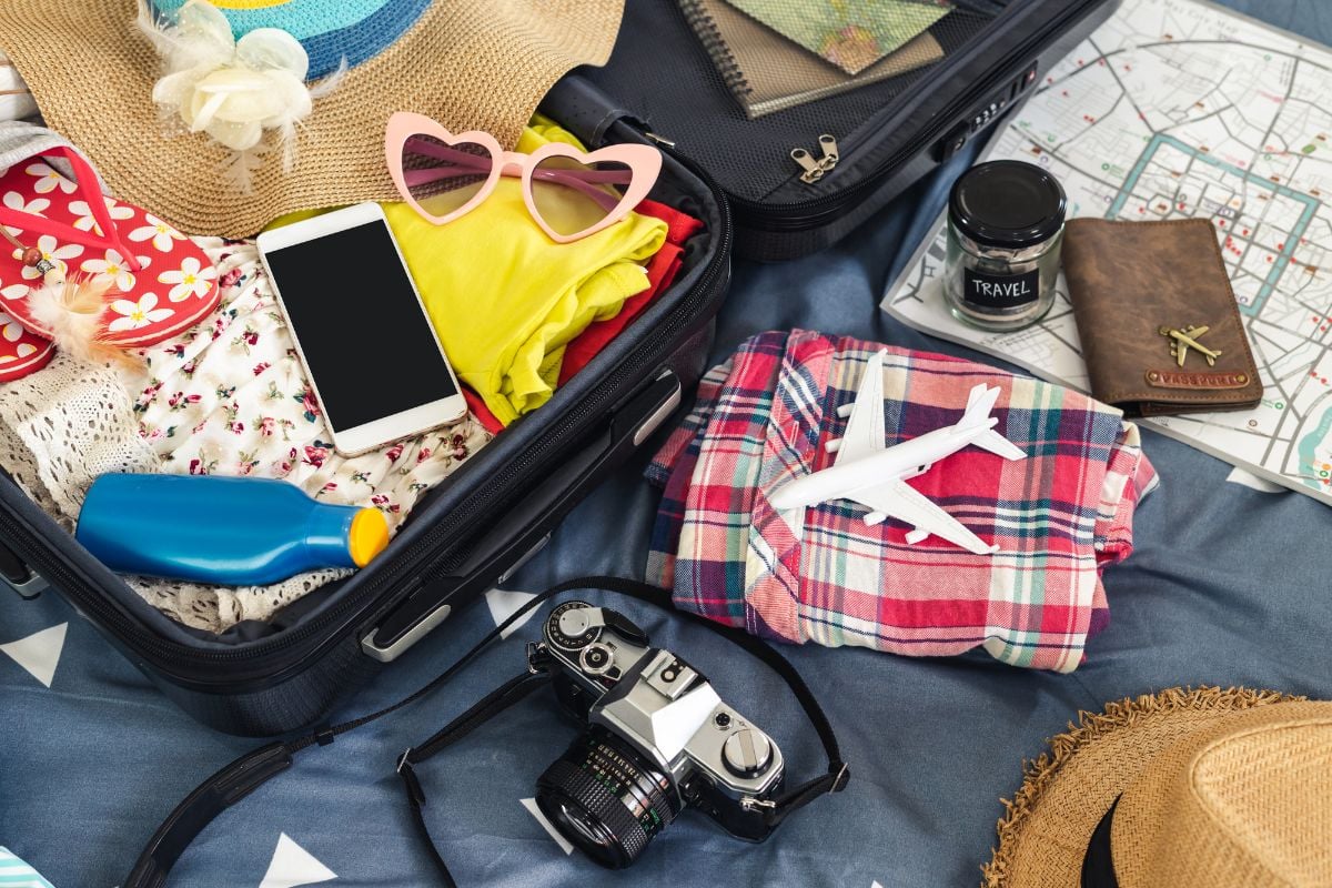 A luggage bag full of accessories for vacation.