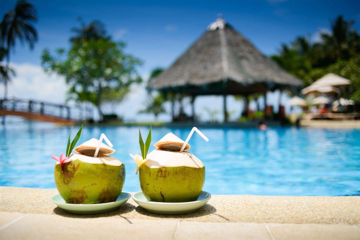 Two coconut cocktails on poolside in Hawaiian resort