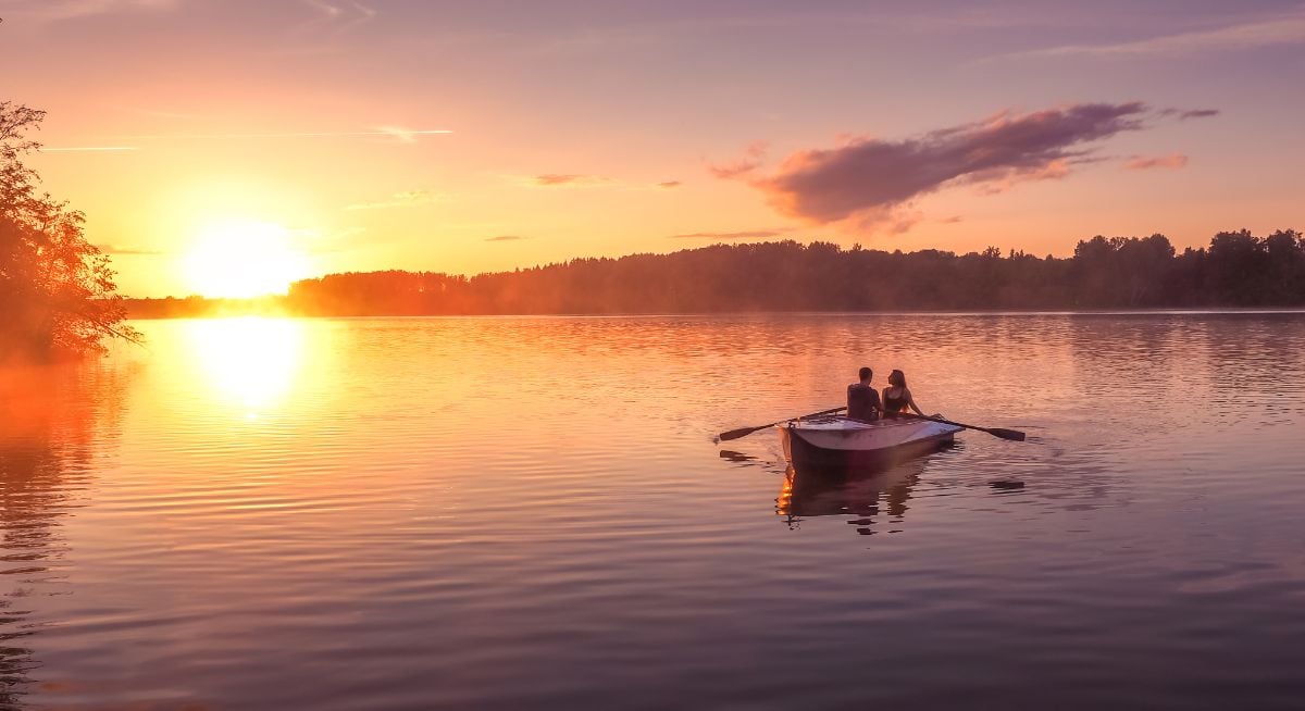 Two canoers on a beautiful lake at sunset