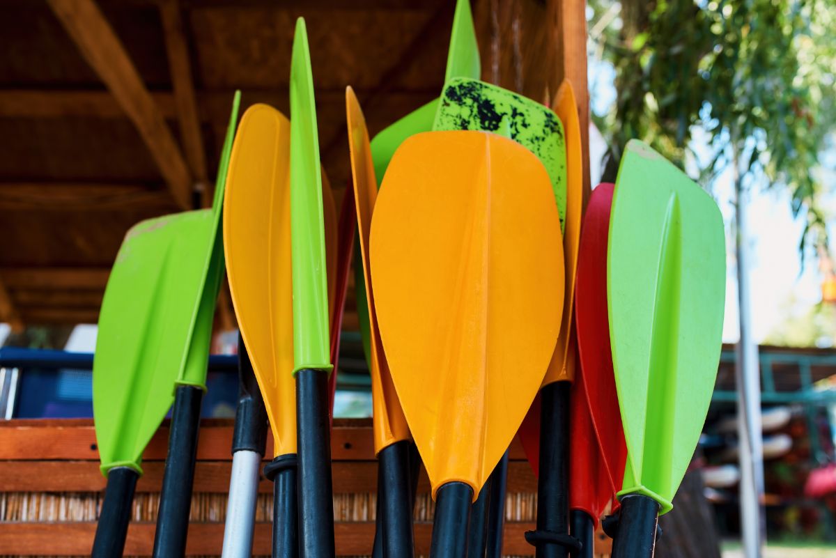 Paddle boards leaning up against a shed for lake day