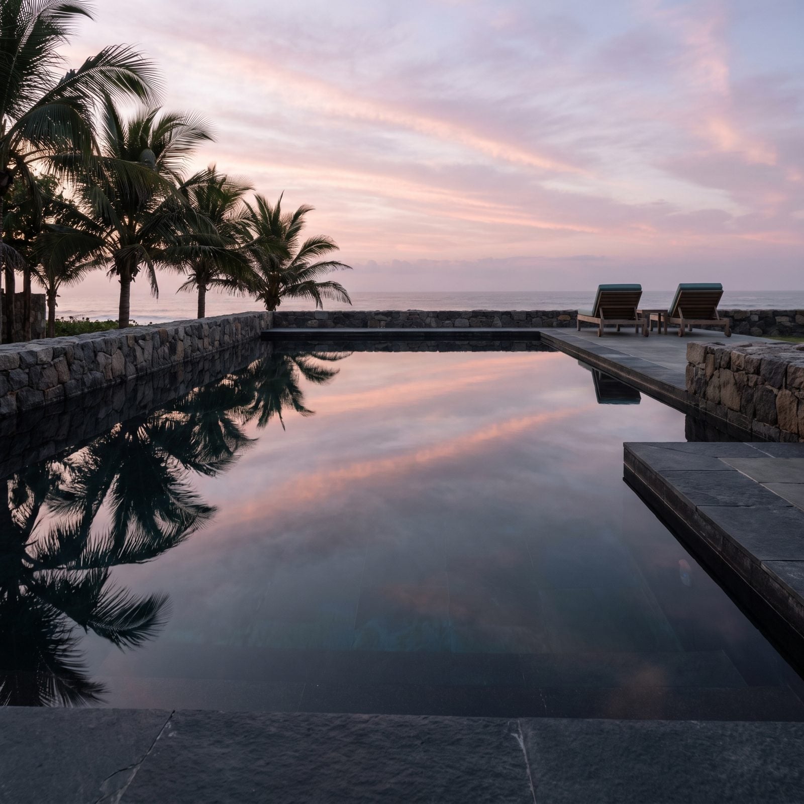 A Black-Bottom Pool That Turns Into a Mirror at Dusk