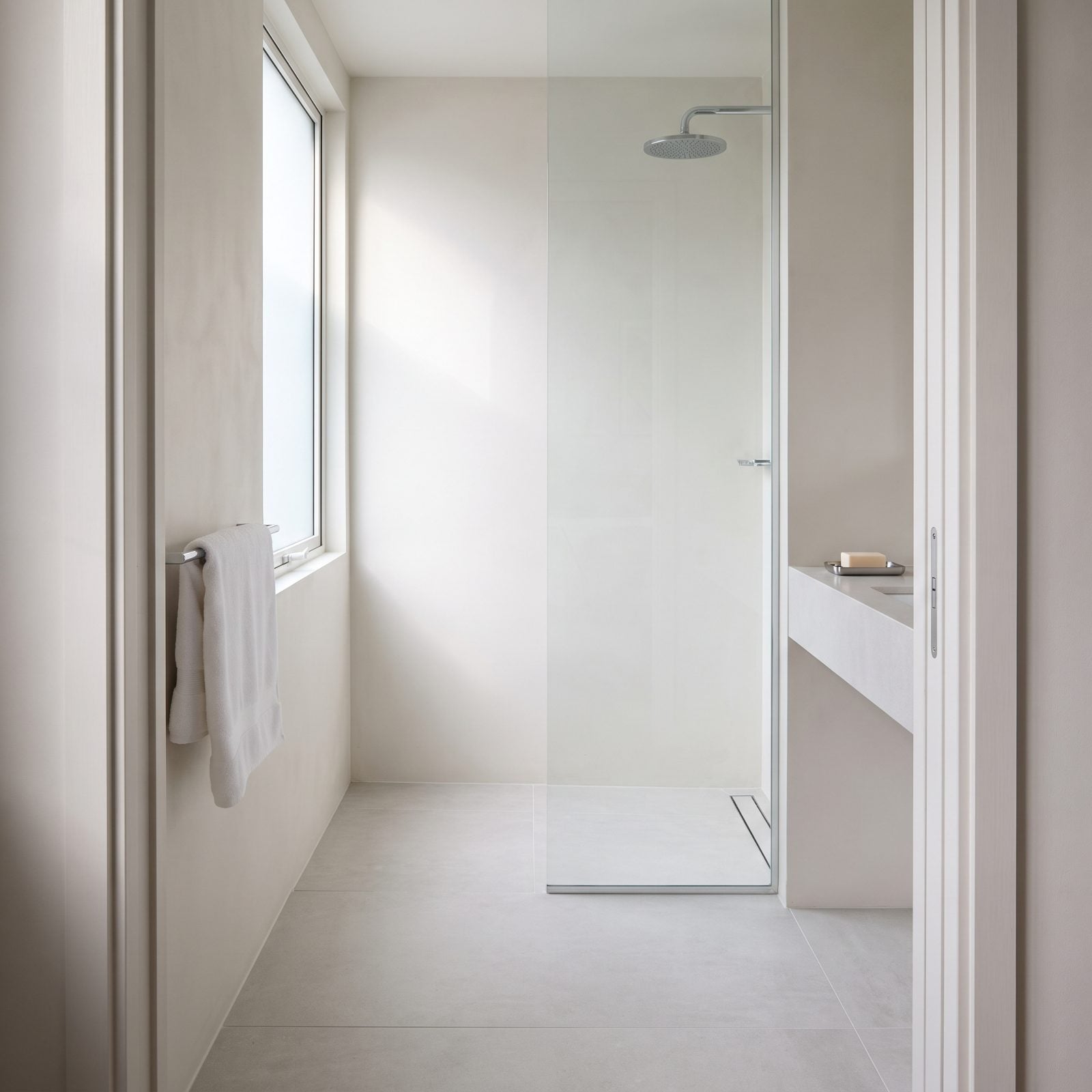 Matching Floor and Shower Tile Pulls the Eye Straight Through