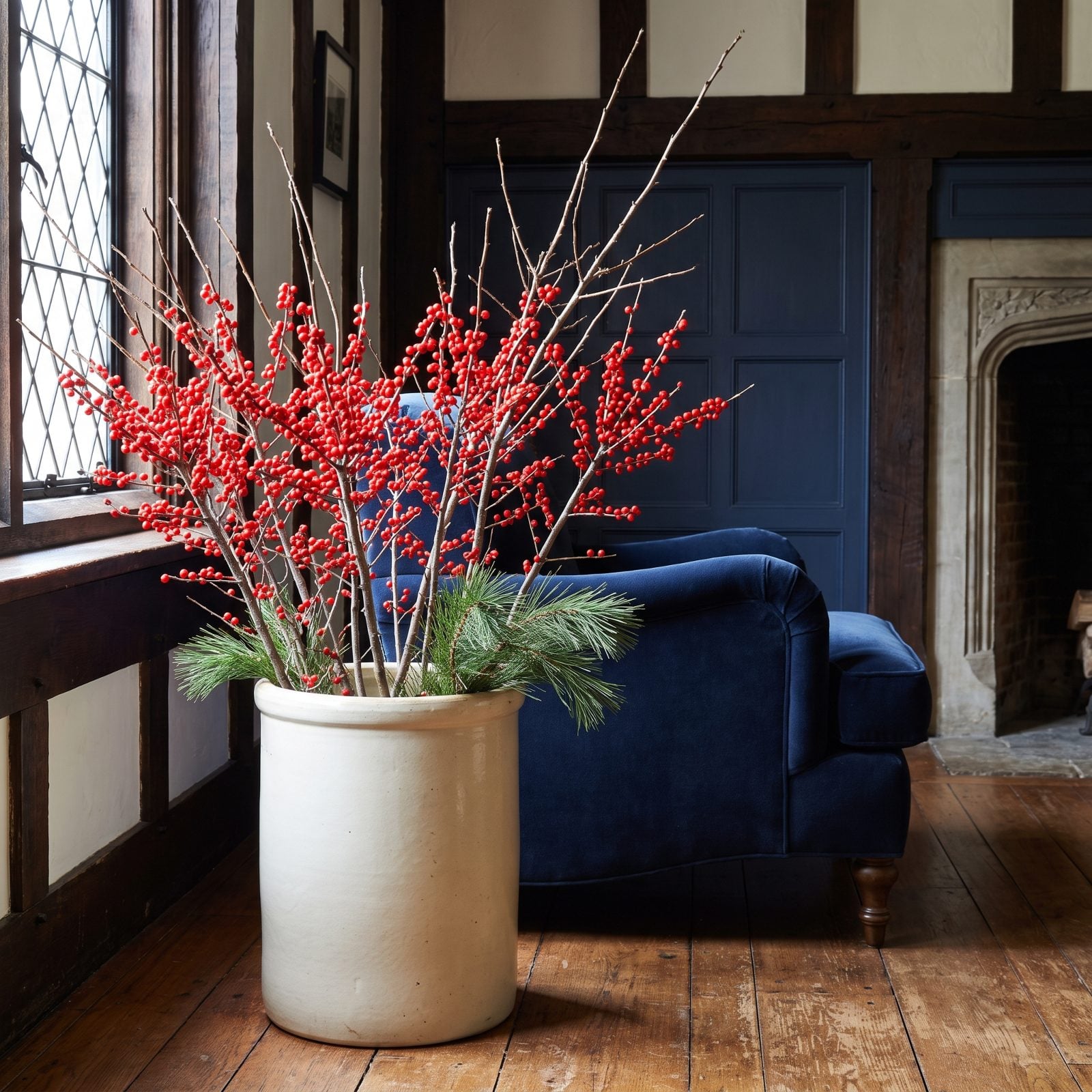 Red Berry Branches Arranged in Stoneware Crocks