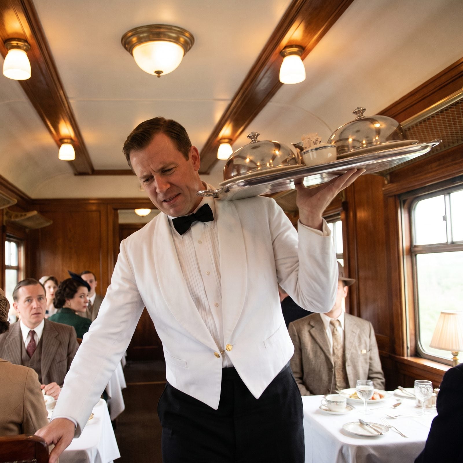 Waiters Balancing Full Trays as the Train Swayed