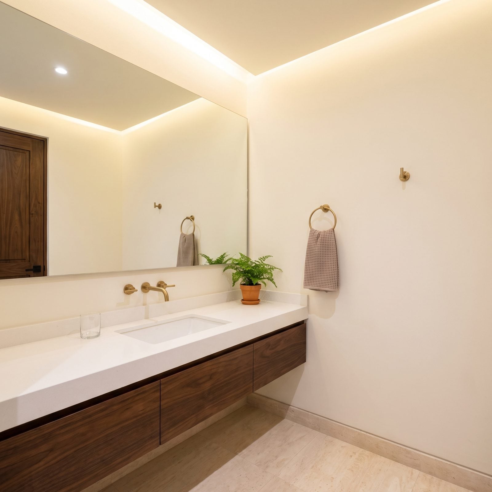 Warm White Walls Keep a Windowless Bathroom Bright